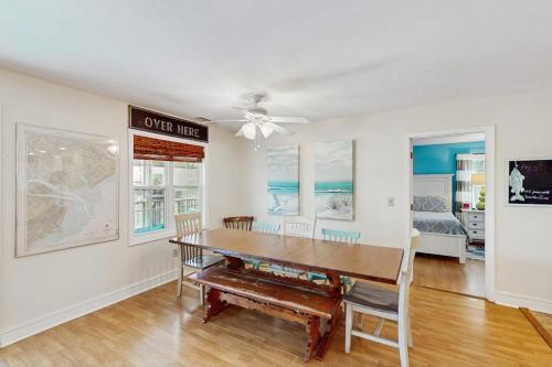 a dining room with a table and a ceiling fan at Summer House in Edisto Beach