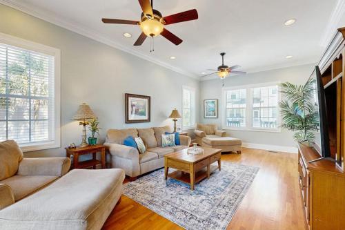 a living room with a couch and a ceiling fan at King Cotton Villa 17 in Edisto Beach