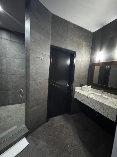 a bathroom with a shower and a sink at Motel Boutique Xpress in Ensenada