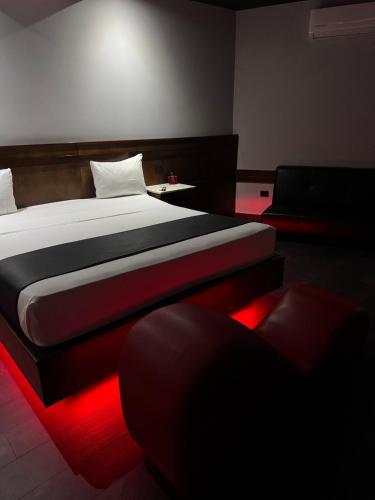 a bedroom with a bed with a red light at Motel Boutique Xpress in Ensenada