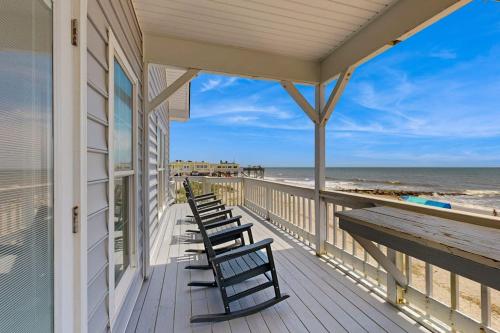 a porch of a house with chairs on the beach at A Shore Thing in Edisto Beach