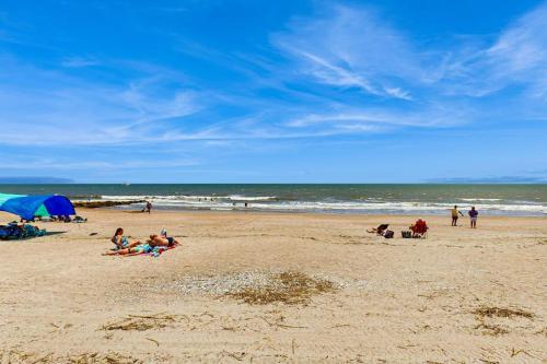 a group of people laying on a beach at A Shore Thing in Edisto Beach