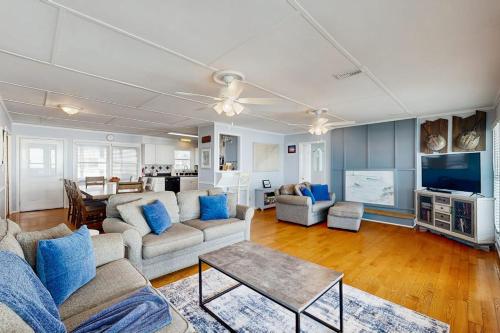 a living room with a couch and a table at Sunrise, Sunset in Edisto Beach