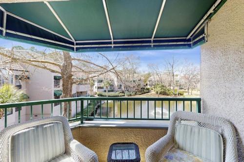 two wicker chairs on a balcony with a view at Anchorage 7444 in Hilton Head Island