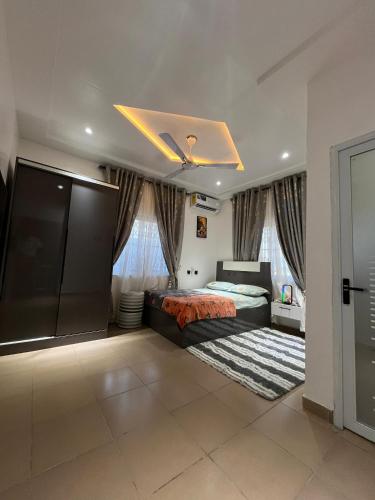 a large bedroom with a bed and a ceiling at Dreamland prestige Homes in Sasabi