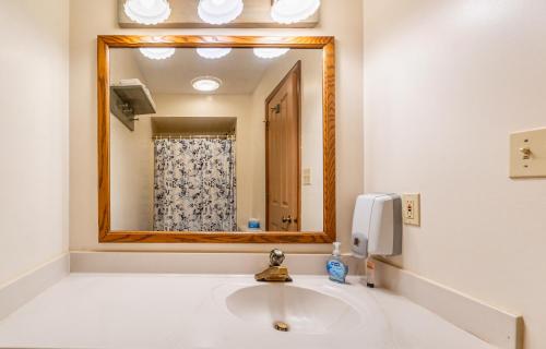 a bathroom with a sink and a large mirror at Hotel Nashville in Nashville