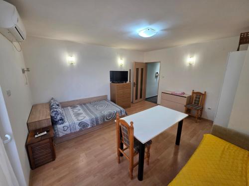 a small room with a table and a bed in it at relax in Plovdiv