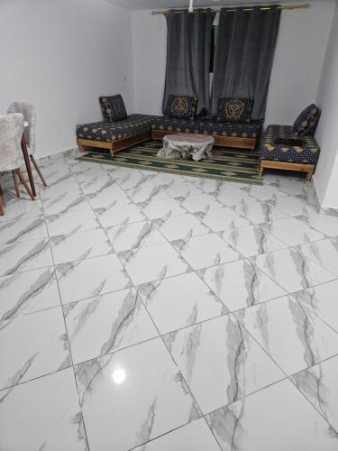a living room with a marble floor and a couch at Aerport arwi accom in Nador Airport