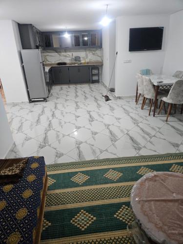 a room with a kitchen and a floor with a table at Aerport arwi accom in Nador Airport
