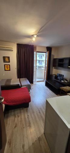 a room with two beds and a red couch at spa in Plovdiv