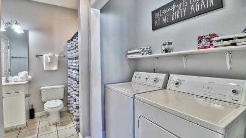 a white laundry room with a washer and dryer at Pet-Friendly Luxury 3BR with Pool Sleeps 8 Near Beach in Myrtle Beach
