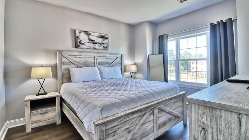 a bedroom with a large bed and a window at Pet-Friendly Luxury 3BR with Pool Sleeps 8 Near Beach in Myrtle Beach