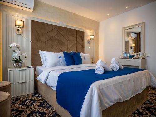 a hotel room with a large bed with towels on it at Hotel Belvedere in Eforie Nord