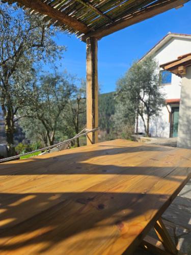 a wooden deck with a view of some trees at Casa dos Pobres in Castro Daire