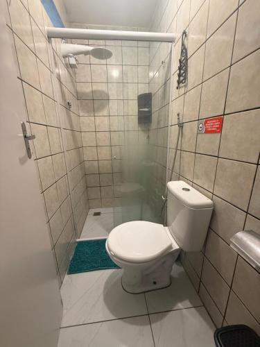 a small bathroom with a toilet and a shower at Cantinho Aconchegante - Apartamento Completo in Bayeux