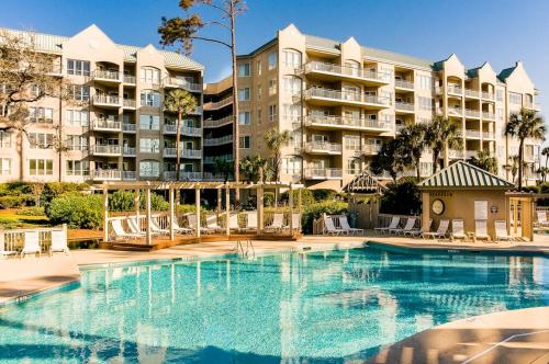 a swimming pool in front of a large apartment building at Windsor Court North 4504 in Hilton Head Island