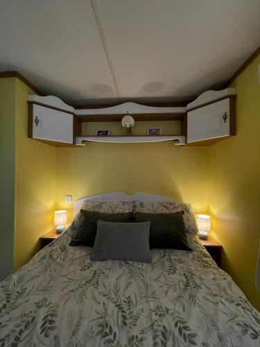 a bed in a room with two night stands and two lamps at Hills View Accommadation in Borrisoleigh