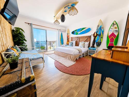a bedroom with a bed and surfboards on the wall at SeaViu Camps Bay in Cape Town