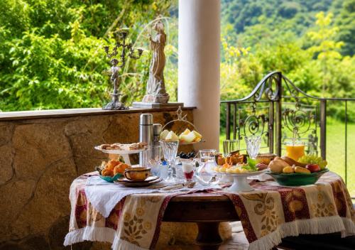 a table with a plate of food on it at Segredo da Serra Pousada Boutique in Tiradentes