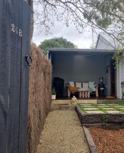 a backyard view of a house with a garage at Brushwood Studio - Eco Hideaway - Denmark WA in Denmark