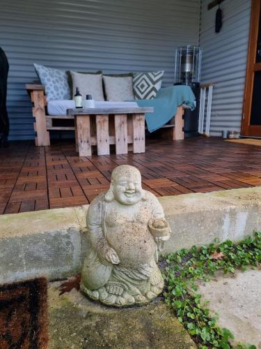 a statue of a bear sitting on a patio at Brushwood Studio - Eco Hideaway - Denmark WA in Denmark