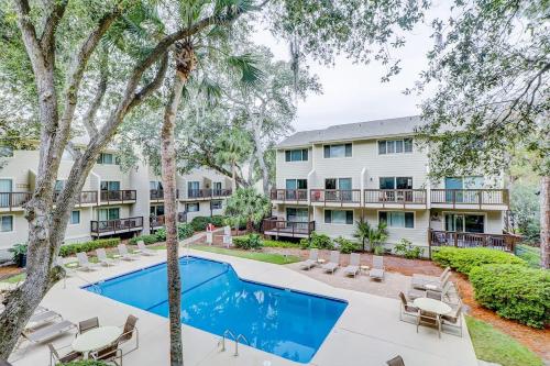 an apartment with a swimming pool and a resort at Beach Club Bungalow in Hilton Head Island