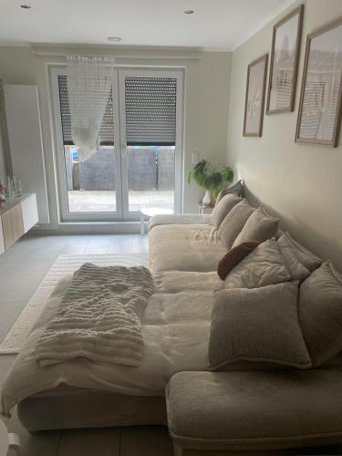 a large bed sitting in a room with a window at studio siesta in Pétange