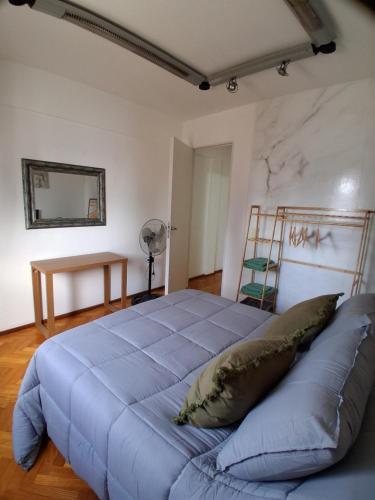 a bedroom with a blue bed in a room at Departamento al Canal in Buenos Aires