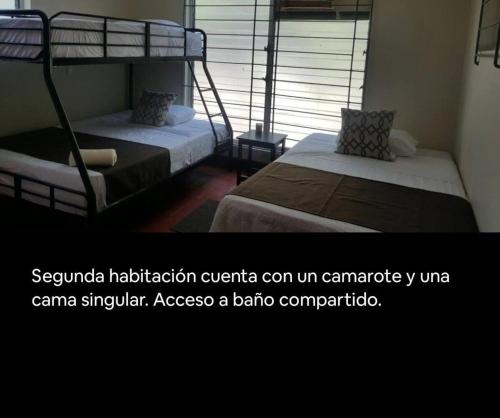 a bedroom with two bunk beds and a window at Bluehaven Austin House in La Paz
