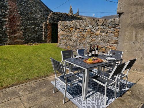 a table with chairs and a plate of food on it at Ardee Retreat - Sleeps 6, Garden, Walk to Town in Ardee