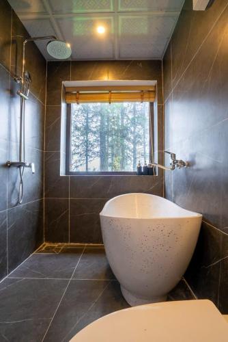 a bathroom with a sink and a toilet and a window at Pine Hill Villa Sapa in Sapa