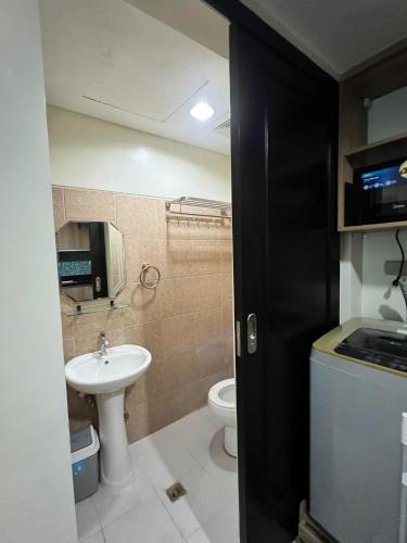 a small bathroom with a sink and a toilet at ONE PAVILLION PLACE in Cebu City