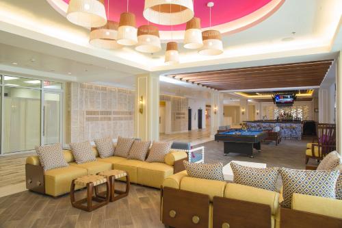 a hotel lobby with couches and a pool table at Warwick Paradise Island Bahamas - All Inclusive - Adults Only in Nassau