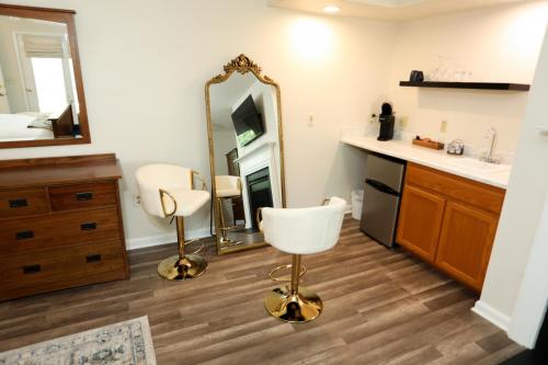 a bathroom with a mirror and a white chair at Cypress River Inn & Spa in Snow Hill