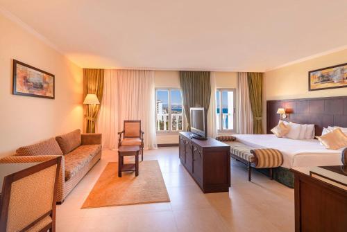 a hotel room with a bed and a couch at Crowne Plaza Antalya by IHG in Antalya