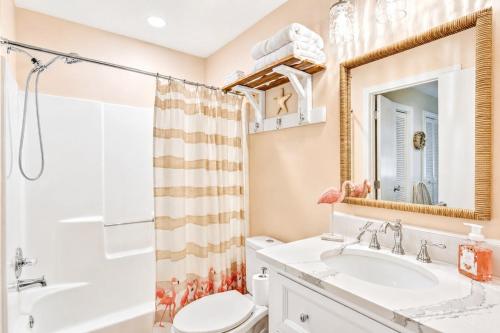 a bathroom with a sink and a toilet and a shower at Bright Coastal Condo in Saint Simons Island