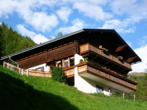 a house on the side of a hill at Appartement Seppenbauer - Seppenbauerhof in Heiligenblut