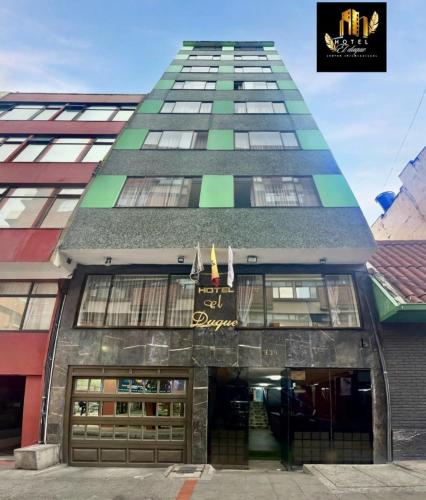 a tall building with a building with a window at Hotel el Duque Internacional, Bogotá in Bogotá