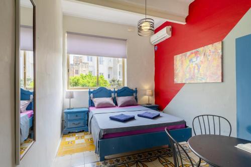 a small room with a bed and a table at Double ensuite room in quiet and budget friendly townhouse in Sliema