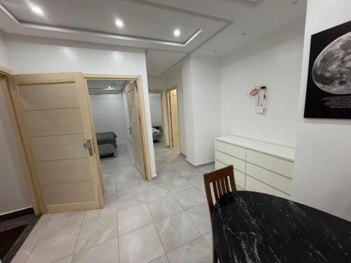 a room with a table and a room with a door at Reda Appartements Al Hoceima in Al Hoceïma