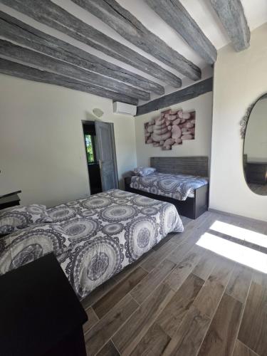 a bedroom with two beds and a wooden floor at Gîte L' authentique in Saint-Germain-des-Bois