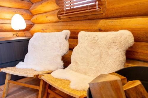 two white mittens sitting on a bench in a cabin at Villa Rusutsu in Rusutsu