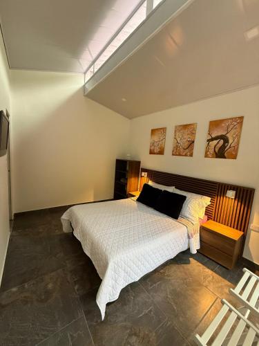 a bedroom with a large bed in a room at Morada Silvestre in La Peña