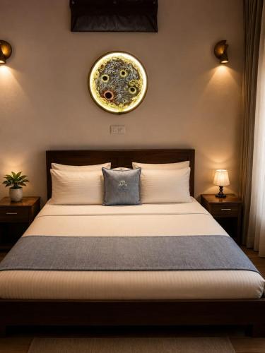 a bedroom with a bed with a clock on the wall at Sea Turtles Bungalow in Bentota