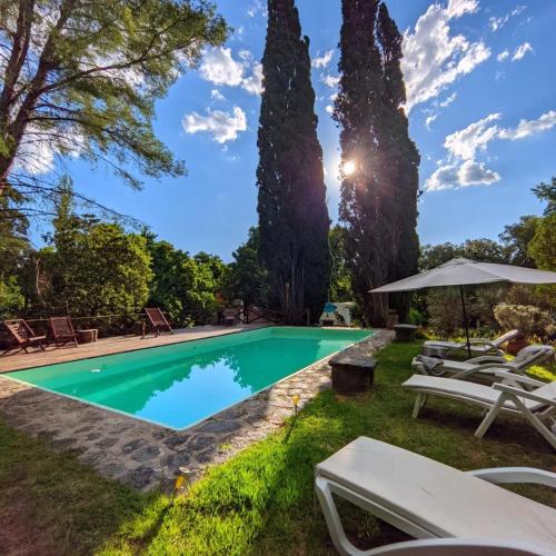 a swimming pool in the yard of a house with trees at cabañas spa el petrel in San Javier