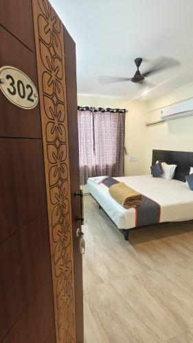 an open door to a bedroom with a bed at Melody Stays Inn in Chennai