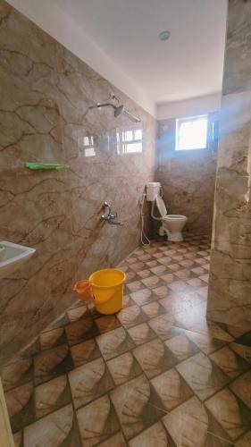 a bathroom with a shower and a sink and a toilet at Melody Stays Inn in Chennai