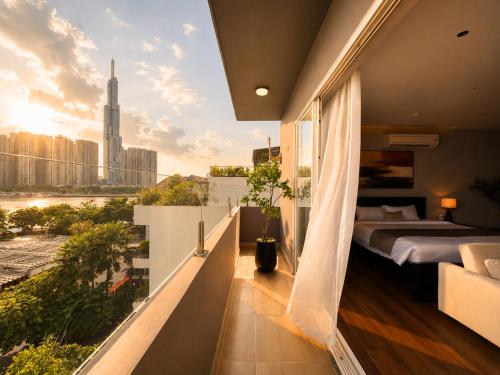 a balcony with a bed and a view of a city at Amana Boutique Riverside - An Khanh in Ho Chi Minh City