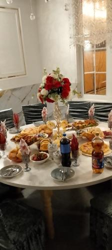a table with a bunch of plates of food on it at House Ali in Chirganak