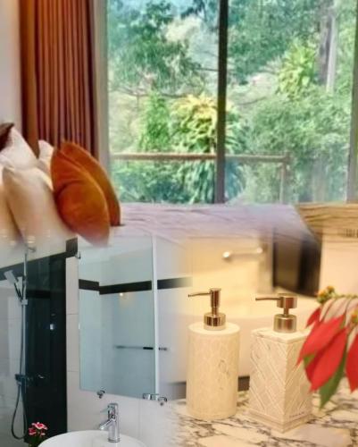 a bathroom with two sinks and a large window at Ella Pine Crest in Ella